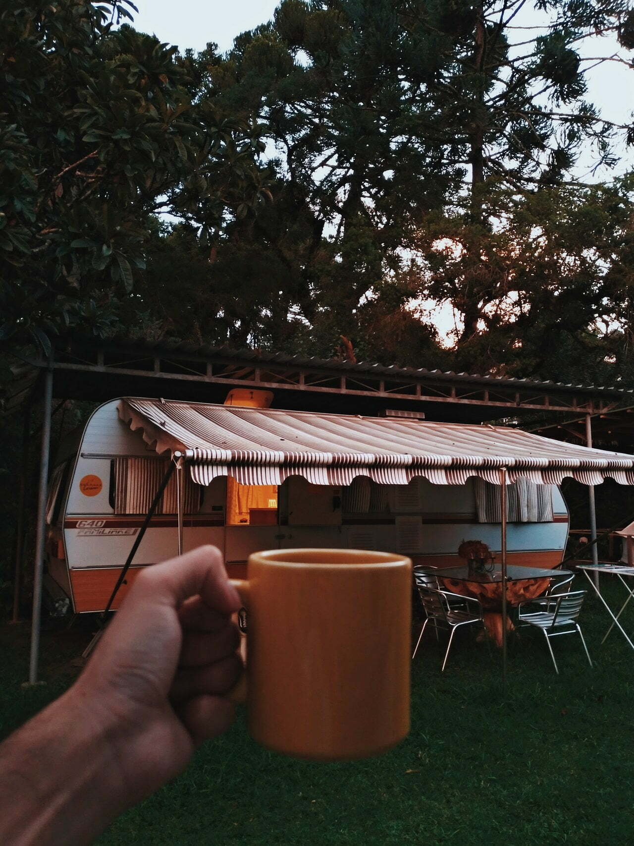 a hand holding a cup of coffee