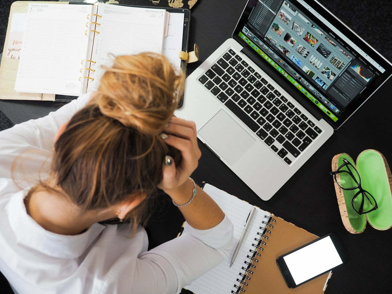 a woman sitting in front of a laptop