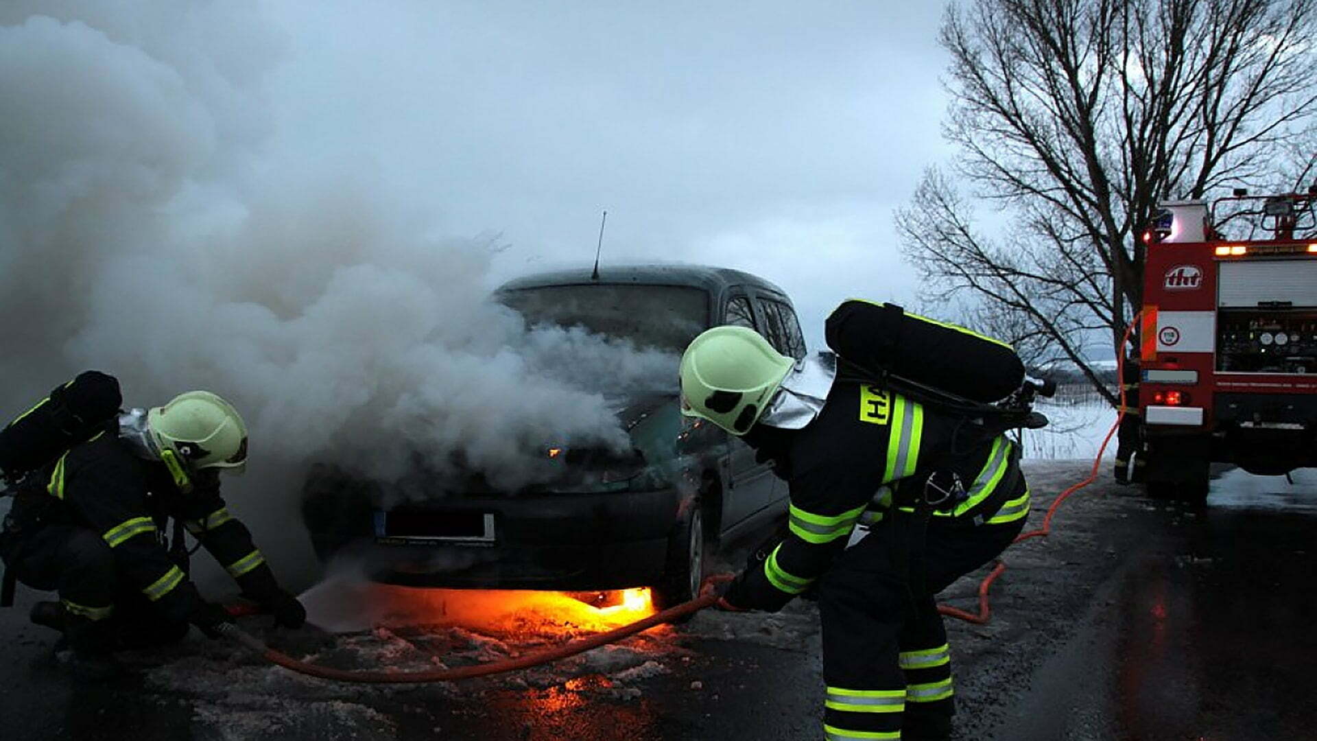 a firefighter spraying water on a fire