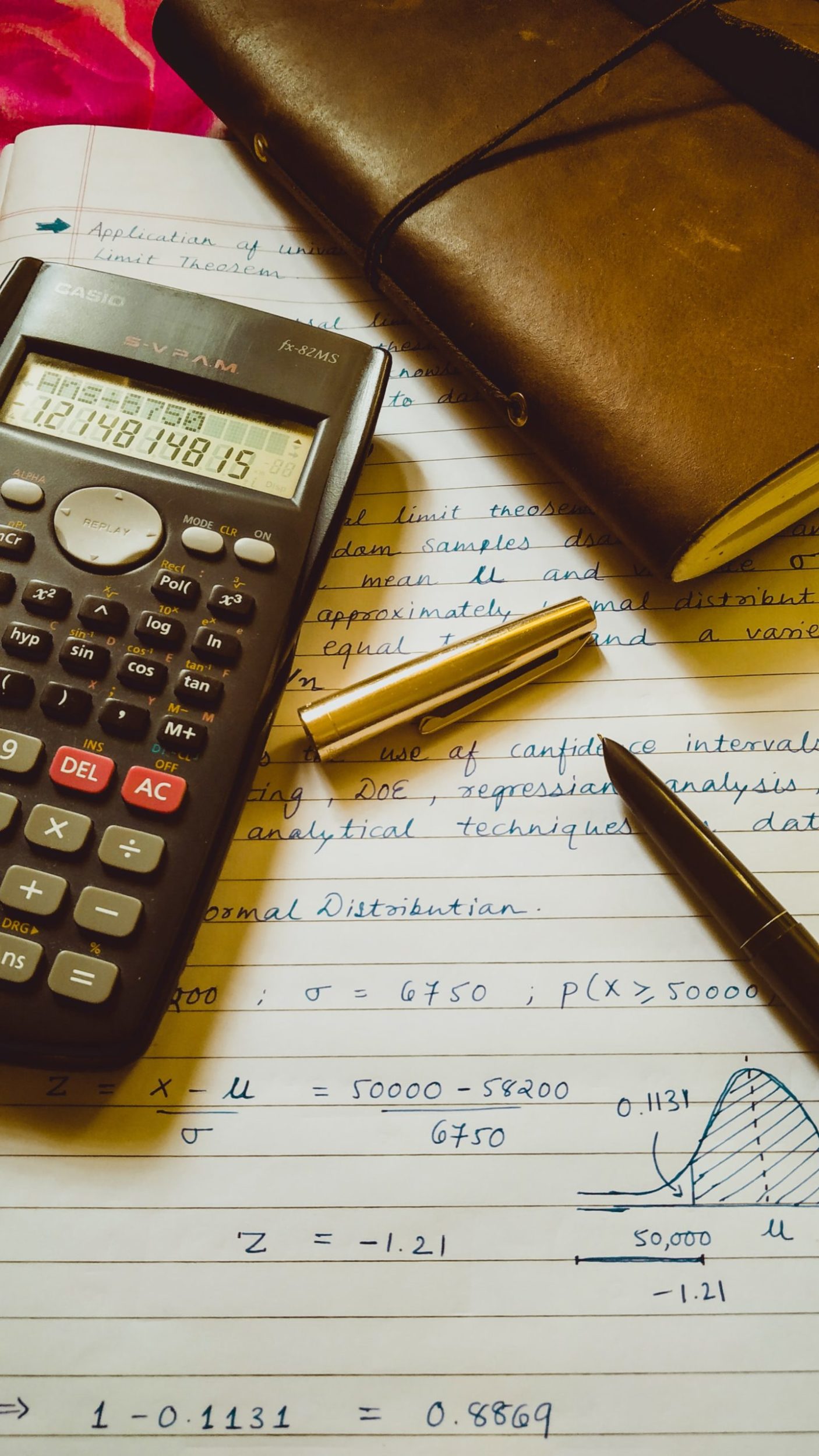 a calculator and a pen on a table