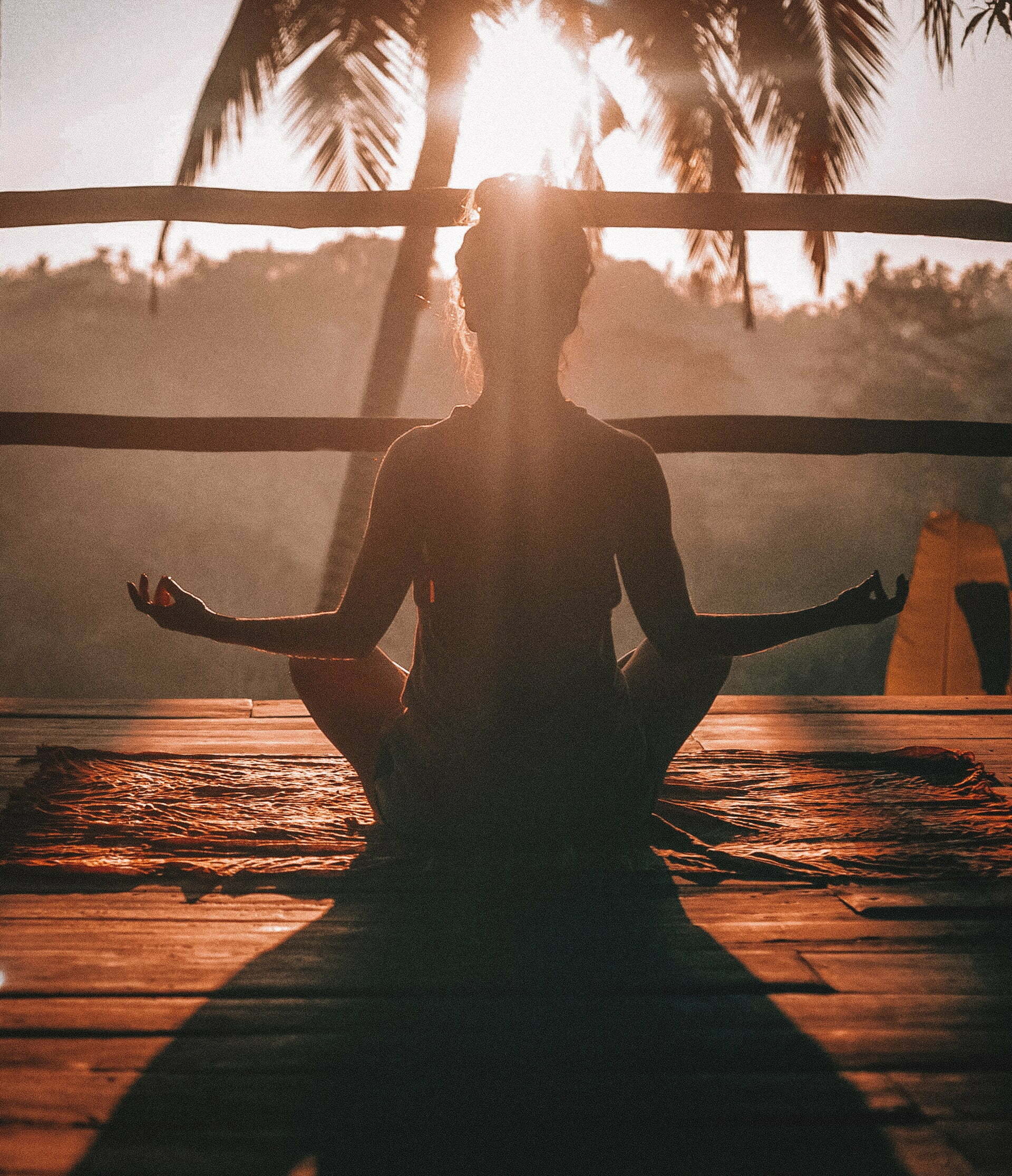 a person standing in front of a sunset