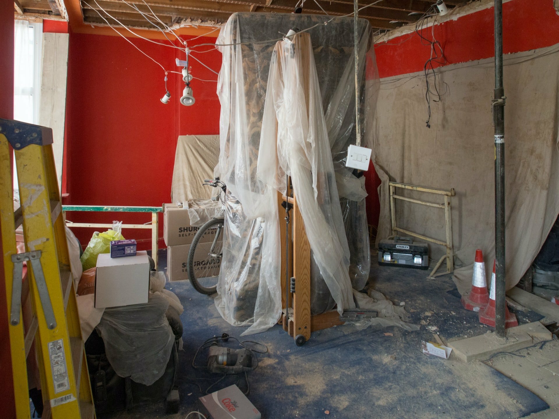 a room with a lot of clothes from the ceiling