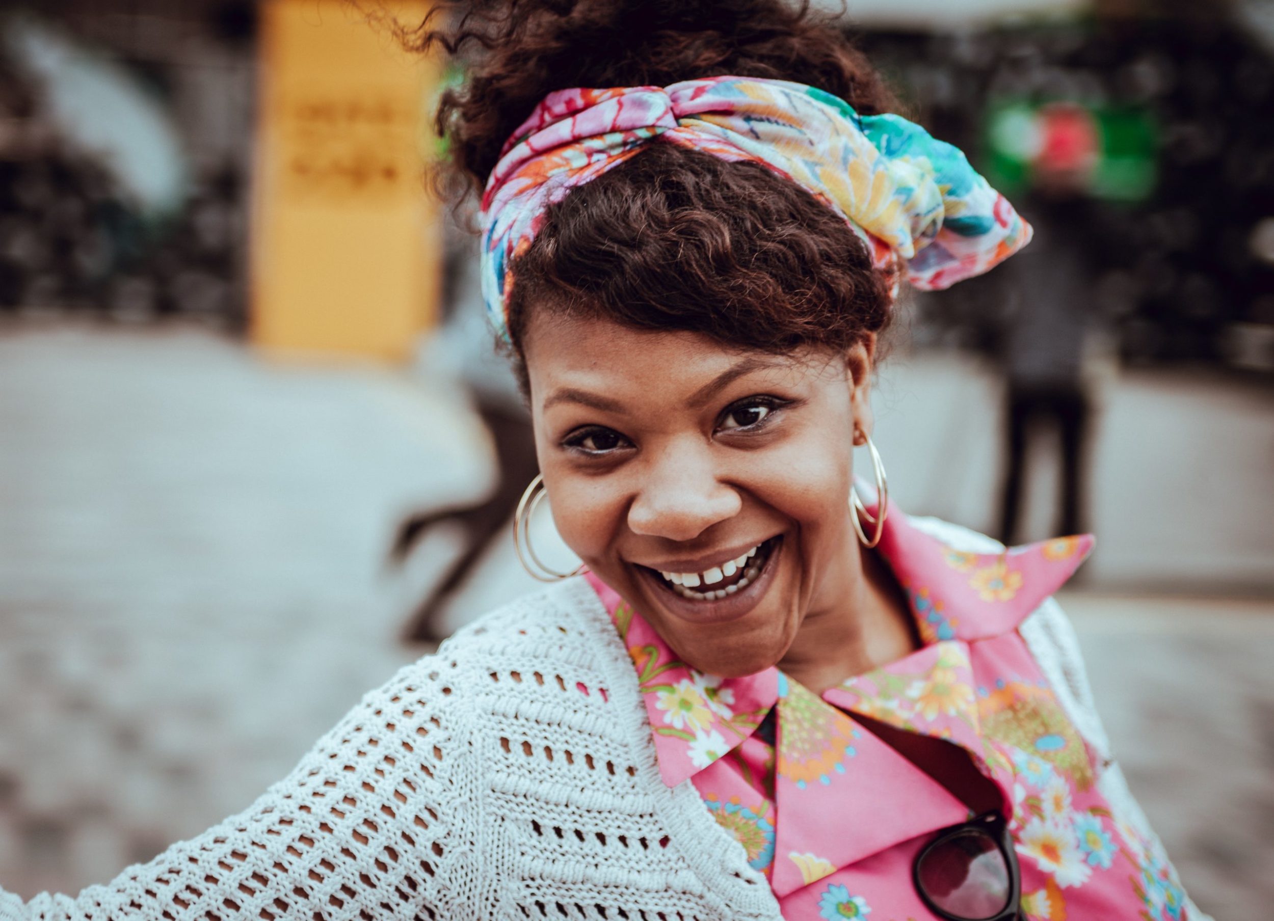 a smiling girl wearing a colorful scarf