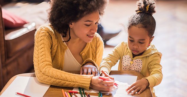 a person and a child looking at a book
