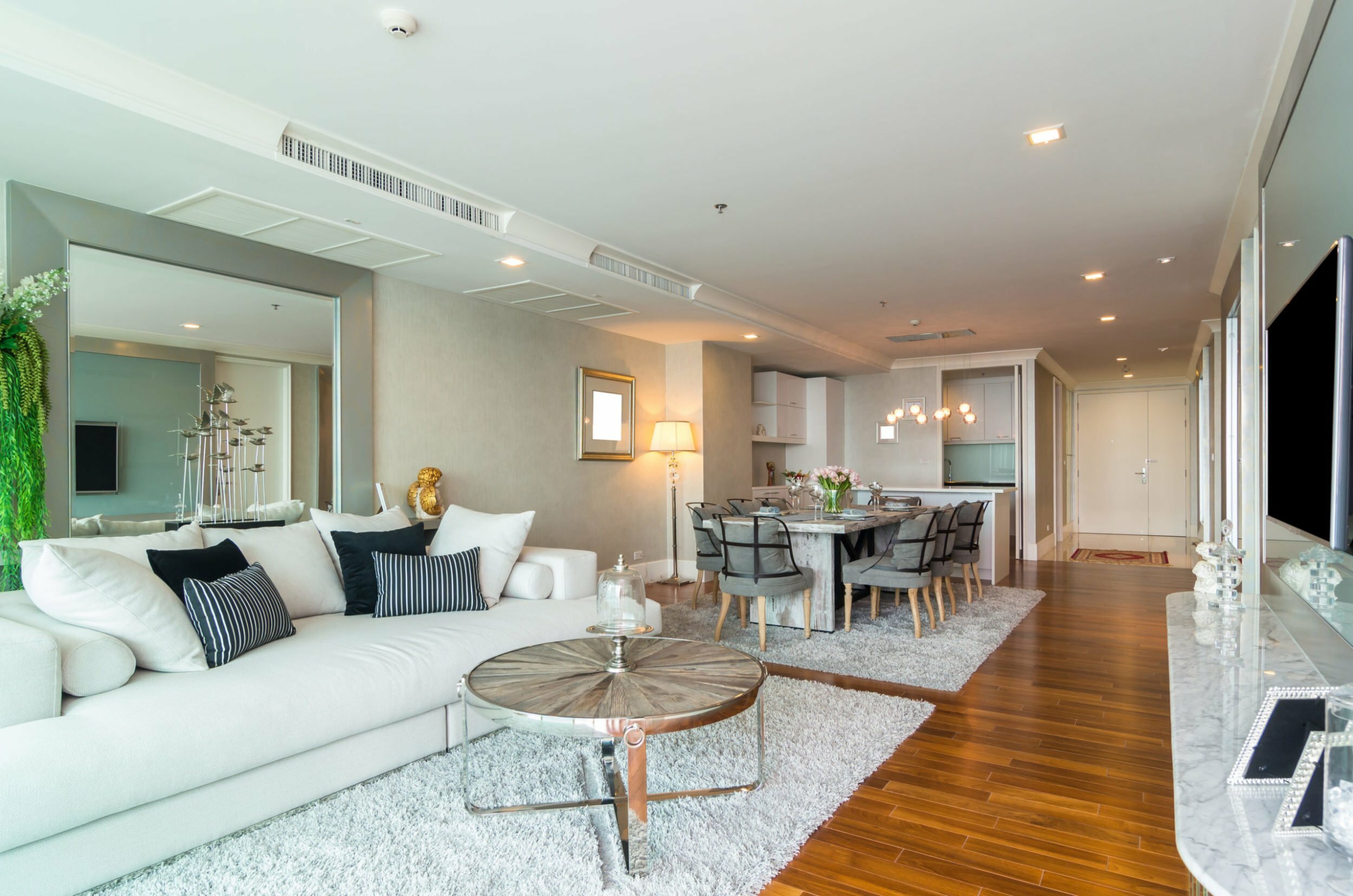 a living room with a large white couch and a table