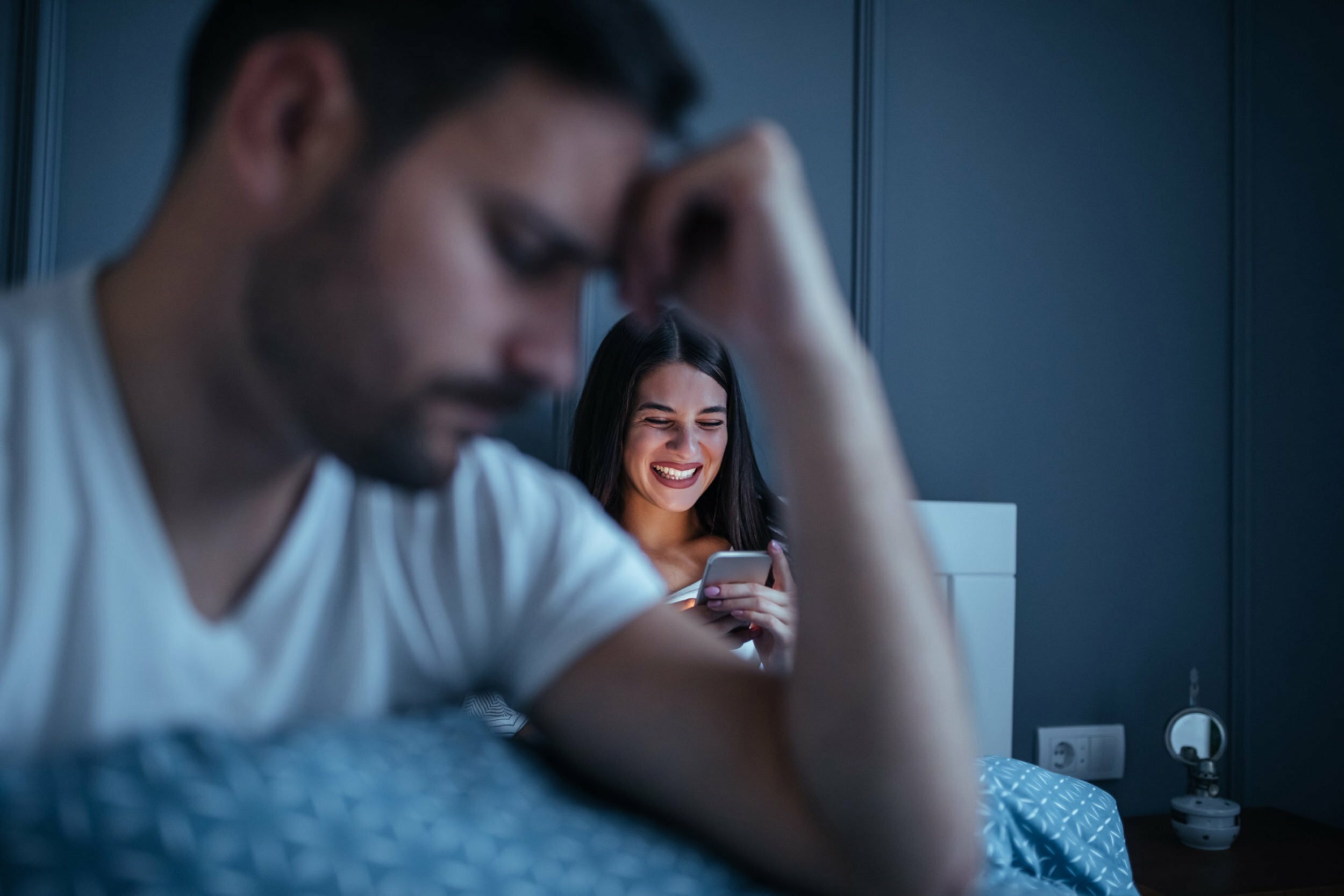 a man and woman looking at a phone