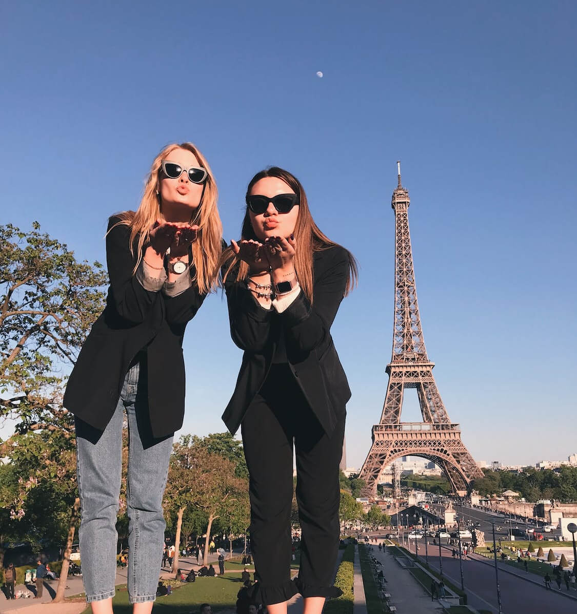 a man and woman posing for a picture in front of a tower