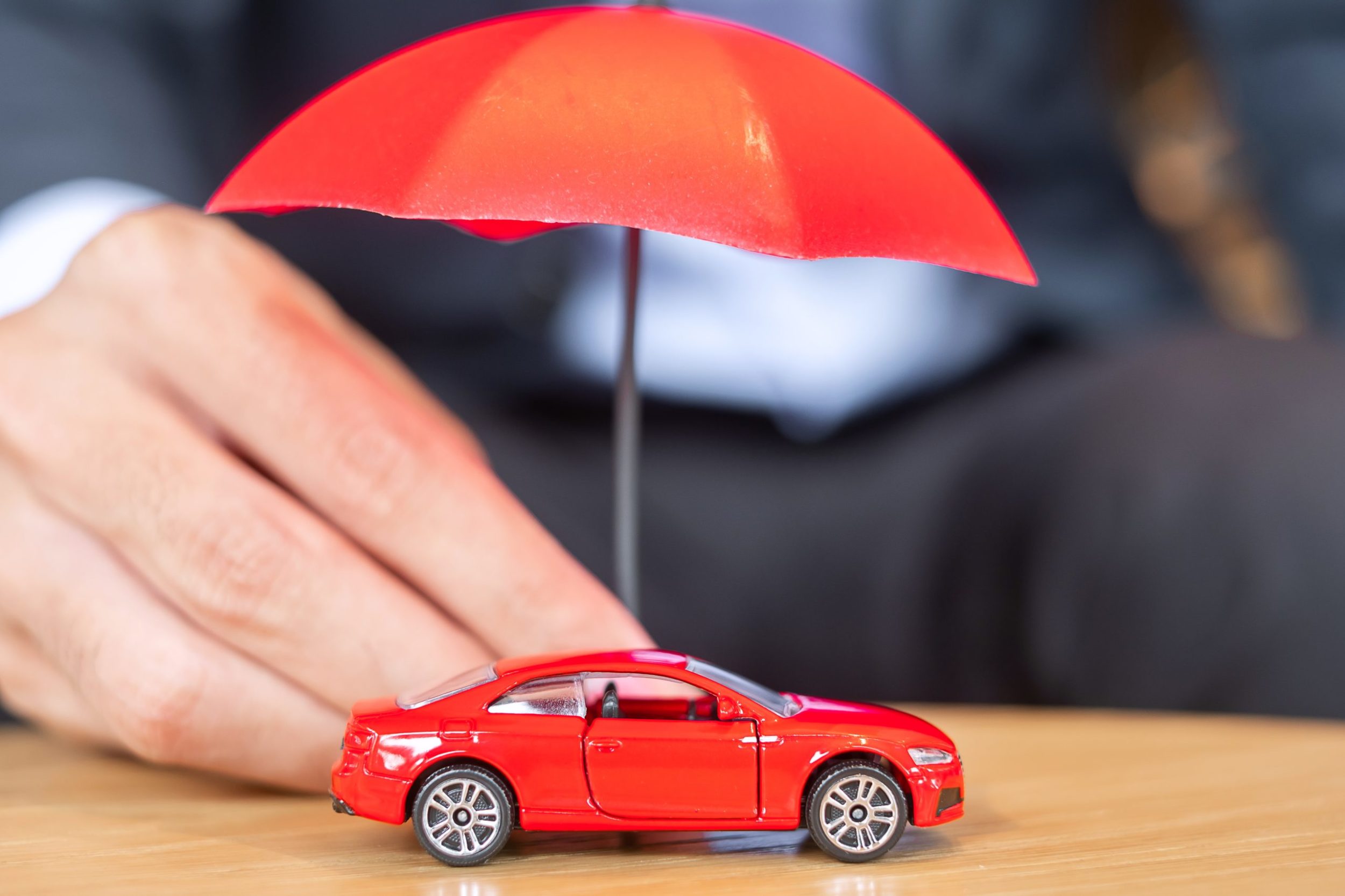 a red car with a black umbrella