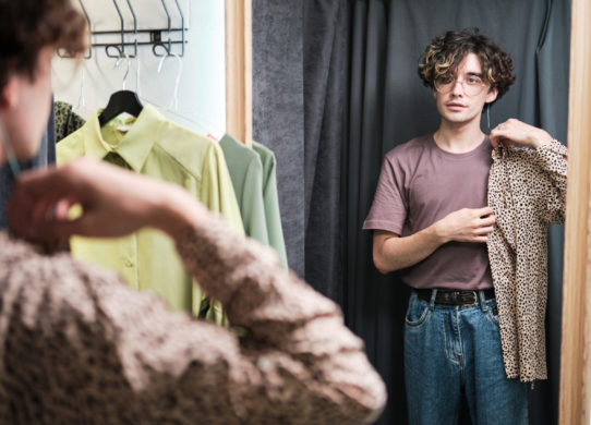 Man trying on new shirt in the fitting room