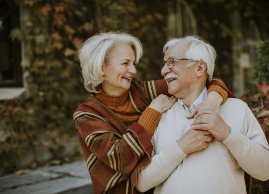Senior couple embracing in autumn park